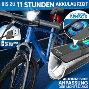 Nextcover LED-Fahrradlicht am blauen Mountainbike mit bis zu 11 Stunden Akkulaufzeit, USB-aufladbar und automatischer Lichtstärke-Anpassung durch LightSense-Sensor für optimale Nachtsicht.